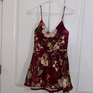 A burgundy romper with floral print.